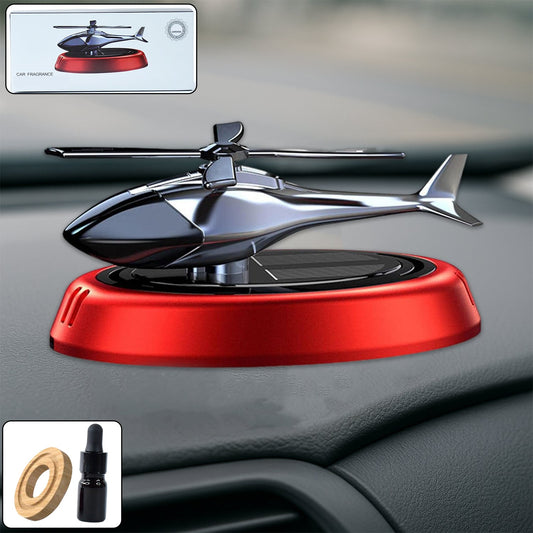 Solar-powered helicopter car air freshener rotating on car dashboard