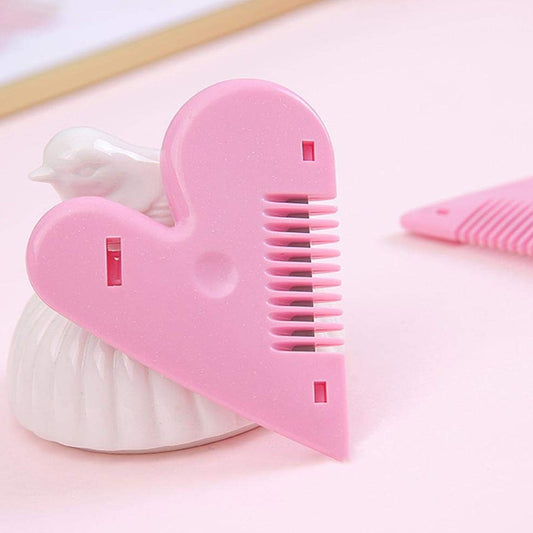 Pink heart-shaped hair cutting scissors with open blades
