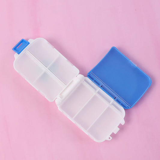 Blue dual-sided pill organizer box showing compartments