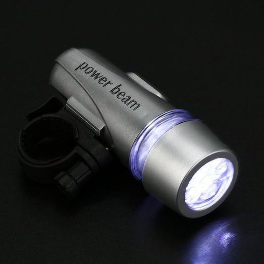 Bright LED bicycle headlight securely mounted on a bike handlebar.