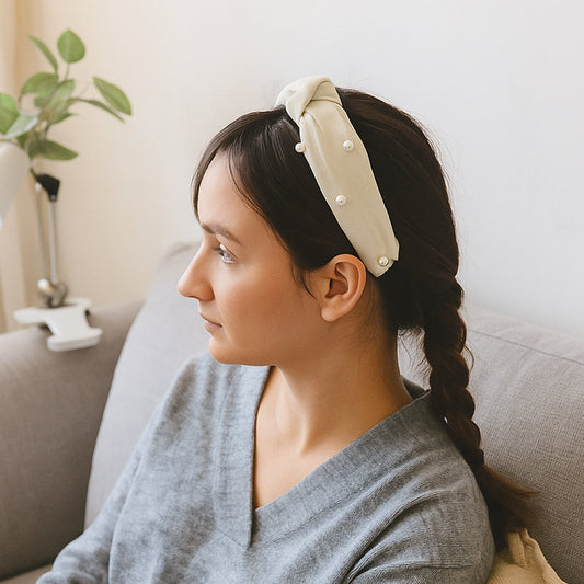 Woman wearing soft ribbed knot hairband with padded design, side view